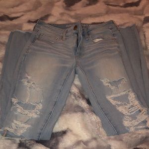 Light wash super ripped American eagle jeans